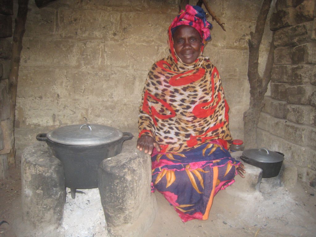 Mere with the two CREATE! cookstoves she built in her home in Thieneba.