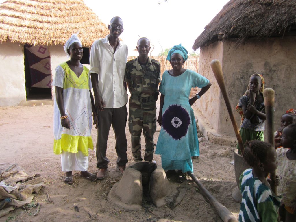 Women in Darou Diadji are excited to show their new cookstoves to CREATE! staff and Captain Thiam of the Senegalese Department of Water and Forestry.