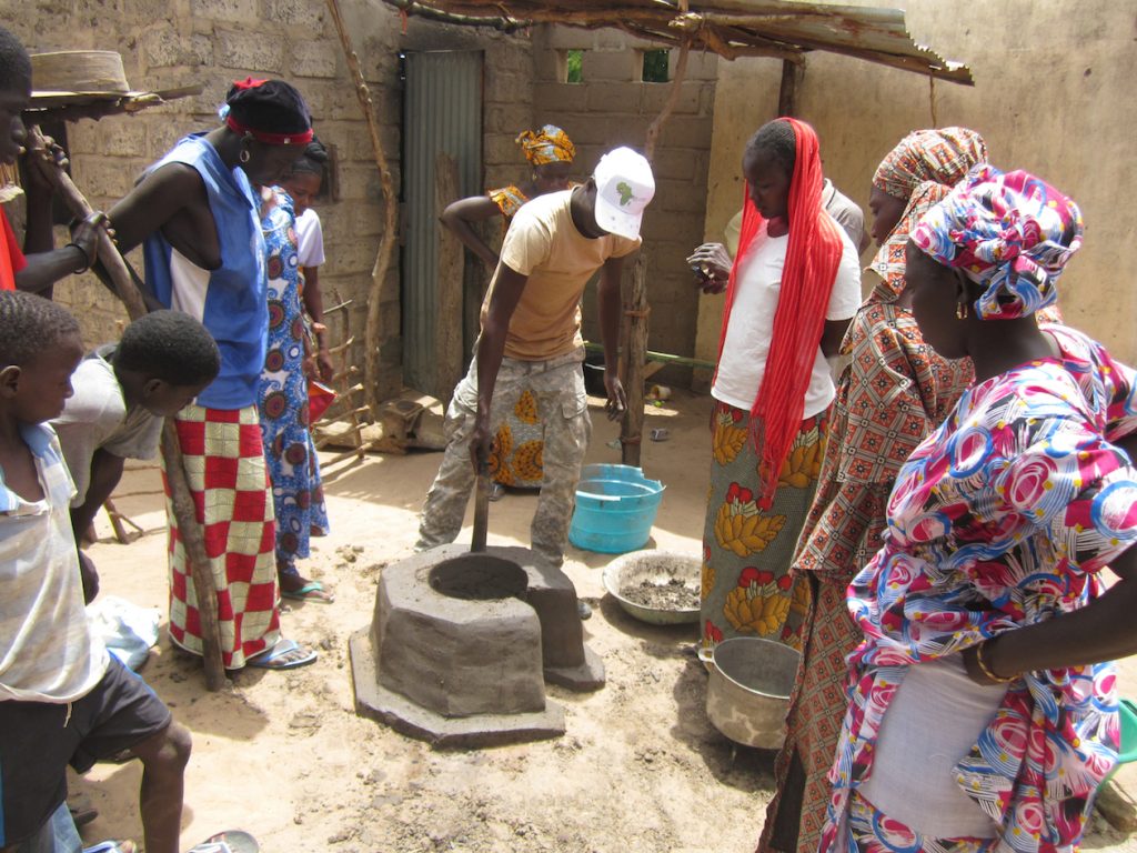 CREATE! Field Technicians demonstrate the final steps of stove construction during training in Keur Sarra.