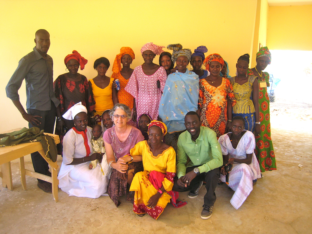 Louise with CREATE! staff members Amadou Diouf (in grey) and Omar Ndiaye Seck (in green) and community members in Ouarkhokh.