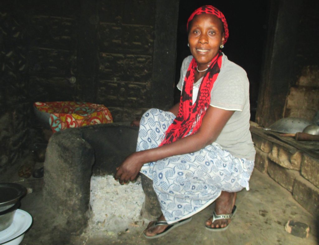 Awa with her cookstove built through CREATE!'s training programs