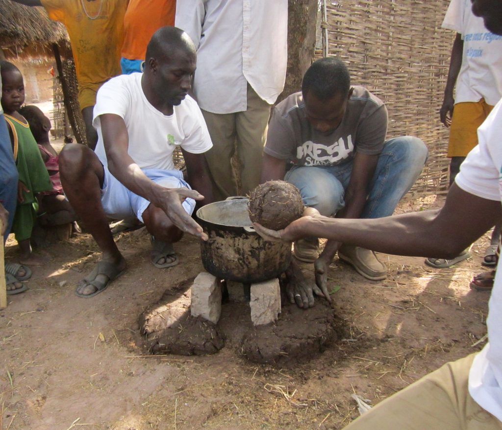 Improved Cookstove Trainings: Participants mix the materials