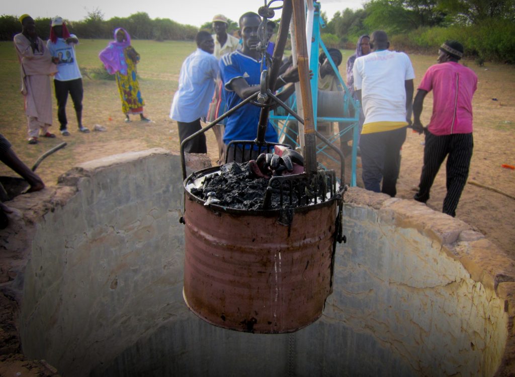 Well rehabilitation: Trash is pulled up from the bottom of the well